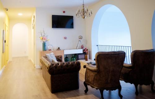 a living room with two chairs and a couch at HI!GO in Vila Nova de Famalicão
