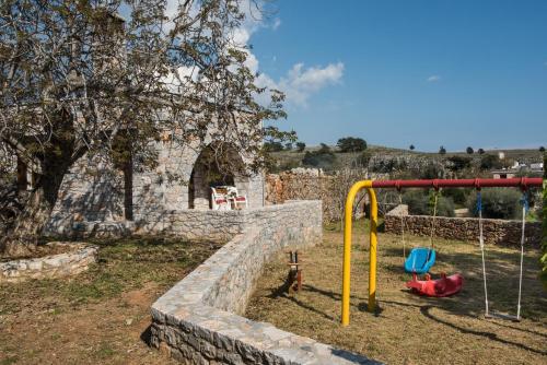a park with a playground with a rock wall at ARADENA TRADITIONAL House 1 in Arádhaina