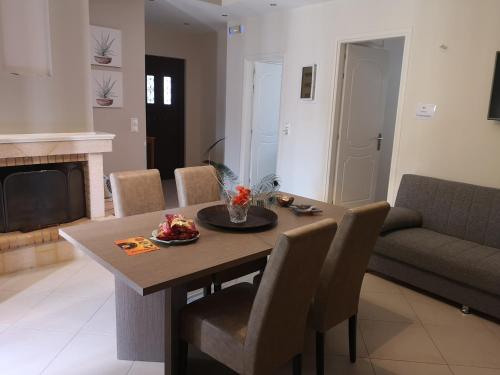 a living room with a table and a couch at Eleni Apartment in Perdhika
