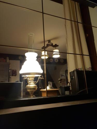 a reflection of a lamp in a mirror at La Bunica in Cisnadioara