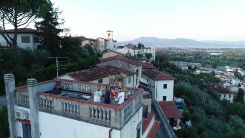 a group of people standing on the balcony of a building at B&B L'Orologio in Signa