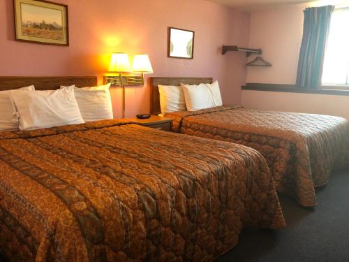 a hotel room with two beds and a window at Executive Inn in McPherson