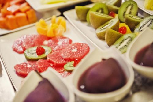 a bunch of different types of fruit on plates at Parador de Cuenca in Cuenca