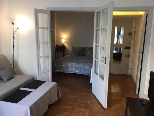 a small room with a bed and a door to a bedroom at Montmartre Lovely in Paris