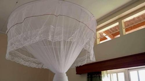 a white curtain is hanging from a ceiling at Murchison Backpackers in Masindi