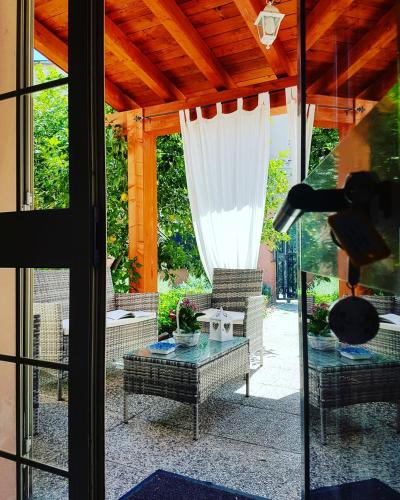 a patio with a glass table and a couch at I Limoni del Sud Sardegna in Assemini