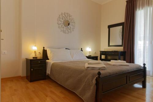 a bedroom with a bed with two towels on it at ANEMOS in Parga