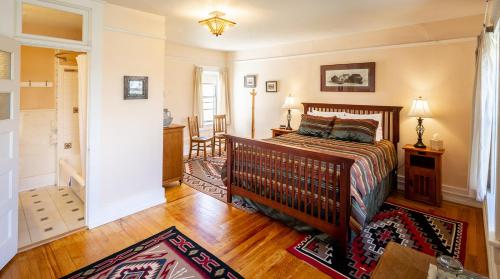 a bedroom with a bed and a room with a hallway at Casa del Gavilan Historic Inn in Cimarron