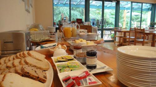 a table with plates of food and bread on it at Heritage Trail Lodge in Margaret River Town