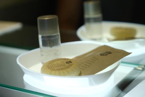 a plastic container with a bottle of water and a paper in it at B&B Grandangolo in Preturo