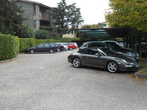 a row of cars parked in a parking lot at Hotel Du Lac et Bellevue in Bardolino