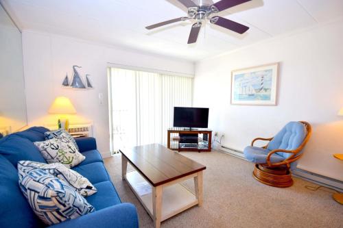 a living room with a blue couch and a table at Breakaway East 109 in Ocean City