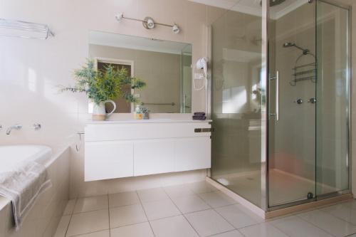 a bathroom with a glass shower and a sink at Torquay Retreats - Anderson in Torquay