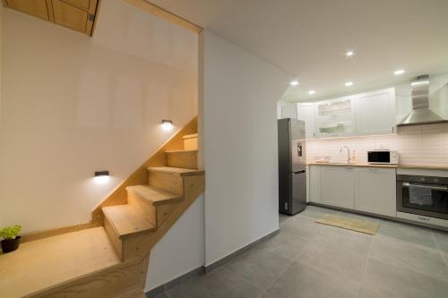 a kitchen with a staircase in the middle at Villa Meereen in Klis