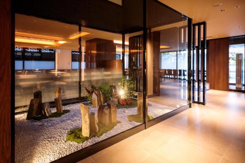 a lobby of a building with statues in a display case at S-peria Hotel Kyoto in Kyoto