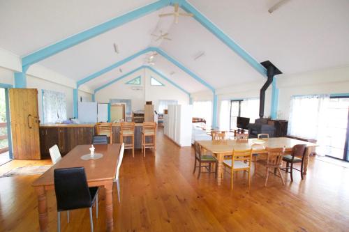 a large room with wooden tables and chairs at Samford Lakes Rural Accommodation in Mount Samson