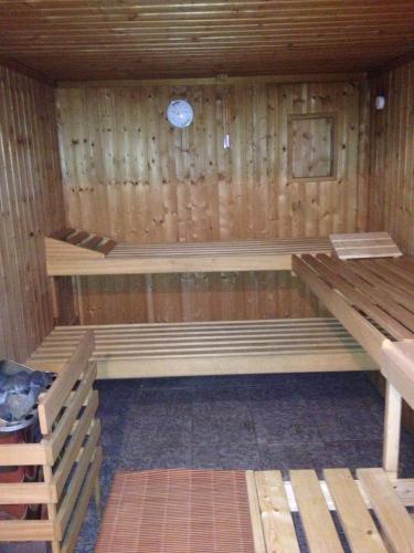 an empty sauna with wooden walls and wooden benches at Hotel Gasthof Turm in Grünhaid