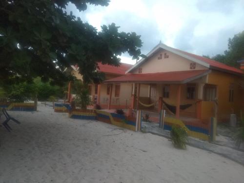a house with a playground in front of it at Ocean holiday in Bira