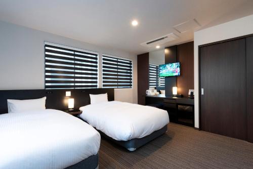 Hotel Kojan tesisinde bir odada yatak veya yataklar