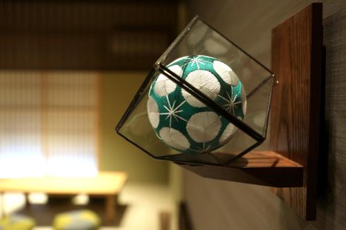 a soccer ball in a glass holder on a wall at Hanaakari in Kanazawa