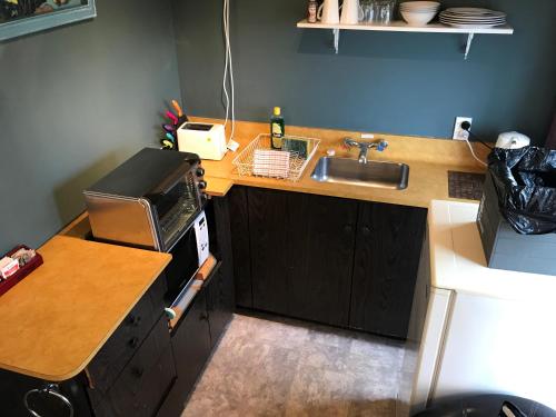 a small kitchen with a sink and a counter at Sandy Feet Accommodation in Christchurch