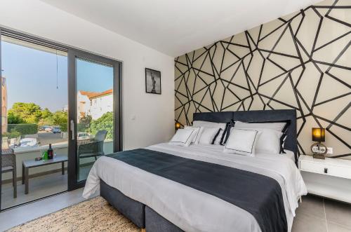 a bedroom with a large bed and a large window at Apartments Villa Adriana I in Srima