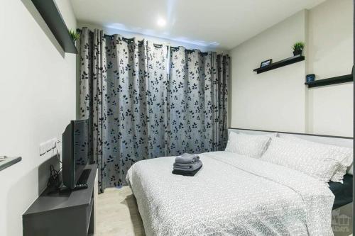a bedroom with a bed and a television in it at the base condo 88/96 in Pattaya Central