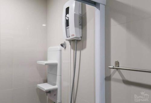a bathroom with a white refrigerator in a room at the base condo 88/96 in Pattaya Central