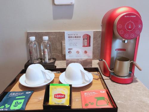 a kitchen counter with a table with dishes and a blender at Home Inn Plus Lanzhou Zhangye Road Pedestrain Street in Lanzhou