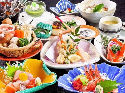 a table with many plates of food on it at Awara Onsen hot spring Koubou Gurabaatei in Awara