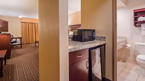 a hotel room with a bathroom with a toilet and a television at Best Western Plus Redondo Beach Inn in Redondo Beach