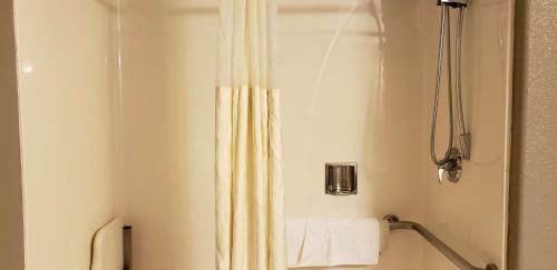 a bathroom with a shower with a shower curtain at Best Western Plus Main Street Inn in Brawley