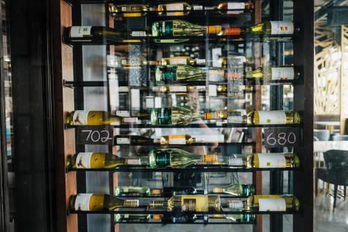 a display case filled with bottles of wine at The Alts Hotel in Palembang