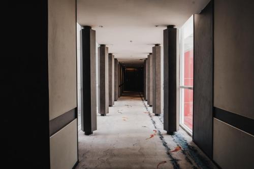 an empty hallway with columns in a building at The Alts Hotel in Palembang