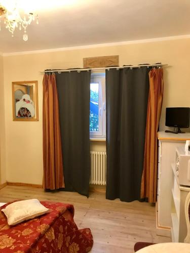 a bedroom with black curtains and a window at B&B Villa Botto in Cossato