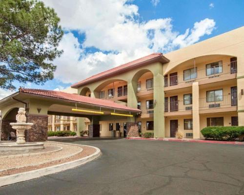 a building with a fountain in front of it at Quality Inn Airport East in El Paso