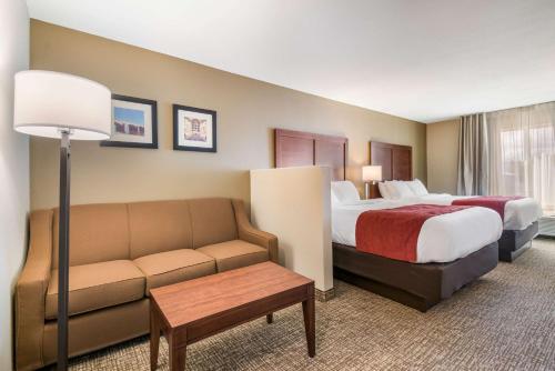 a hotel room with a bed and a couch at Comfort Inn & Suites Harrisburg - Hershey West in Harrisburg