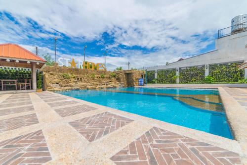 a swimming pool in the middle of a building at RedDoorz Plus @ Starhomes Olivianville in Tarlac