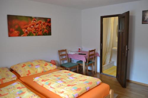 a room with two beds and a table and a mirror at Pension Haus Rohrmoser in Annaberg im Lammertal