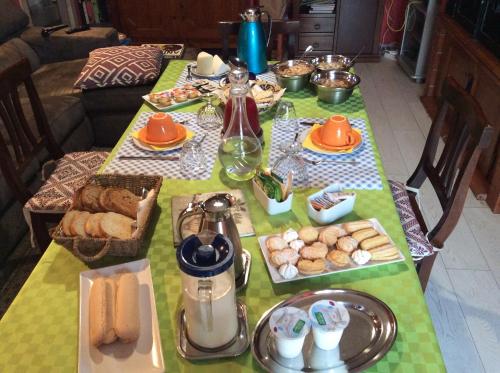 a table with bread and other food on it at B&B Luce Viola in Dorgali