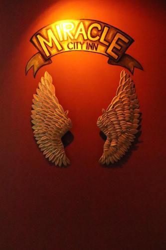 a marquesne university logo on a red wall at Miracle Colombo City Hostel in Colombo