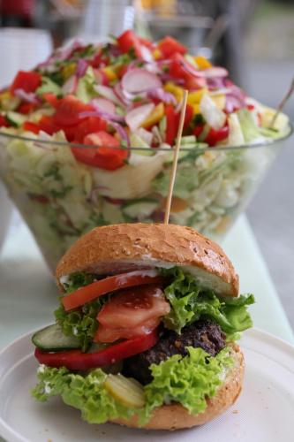 a sandwich on a plate next to a salad at Leśny Ośrodek Szkoleniowy w Puszczykowie in Puszczykowo