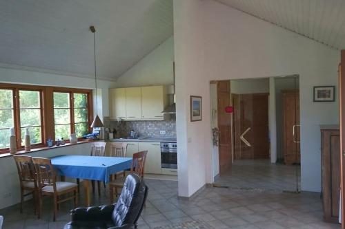 a kitchen with a blue table and chairs at Chalet Forsthof Everstorf in Grevesmühlen