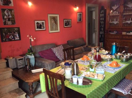 a living room with a table with food on it at B&B Luce Viola in Dorgali