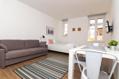 a living room with a couch and a table at Apartments and Rooms Jospino in Mali Lošinj