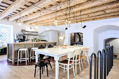 een keuken en eetkamer met een witte tafel en stoelen bij Monastery Garden Bistro & Rooms in Český Krumlov