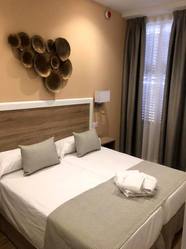 a bedroom with a bed with two towels on it at New Point Opera in Madrid