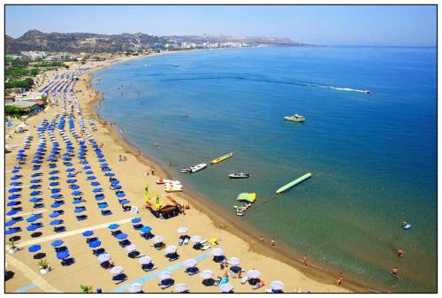 an aerial view of a beach with umbrellas and people at RHODIAN TREASJURE Spiridione Studios in Faliraki
