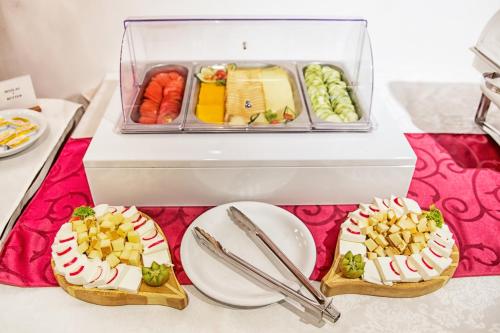 a table with two plates of food and a box of food at Hotel Putnik in Novi Sad