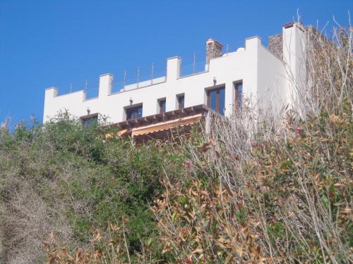 a white house on top of a hill at Beach Villa Pantheon in Pomos